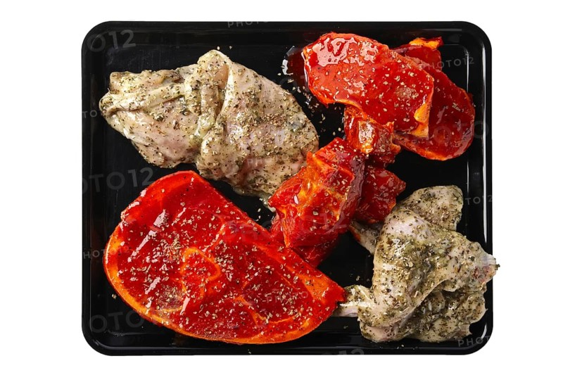 Marinated varieties of meat ready for grilling isolated on white background