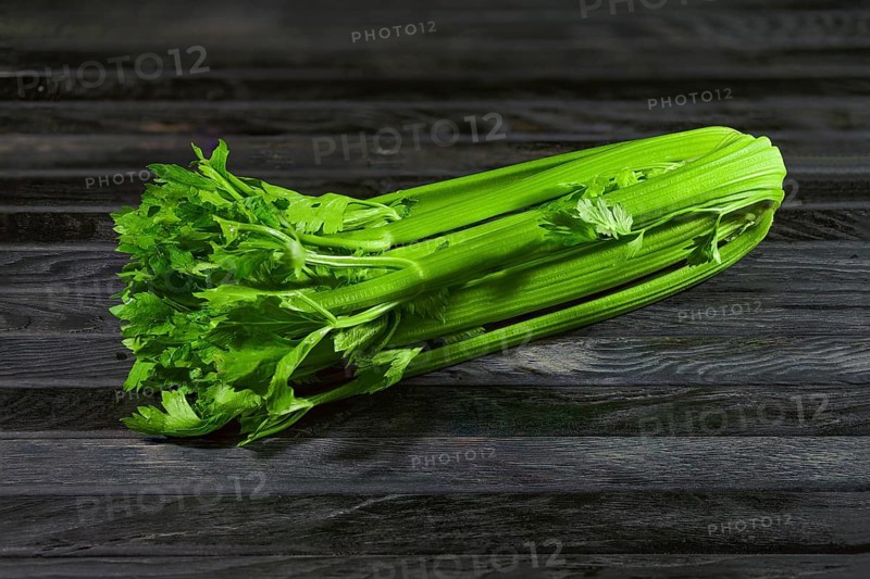 Fresh wet celery on an old kitchen table