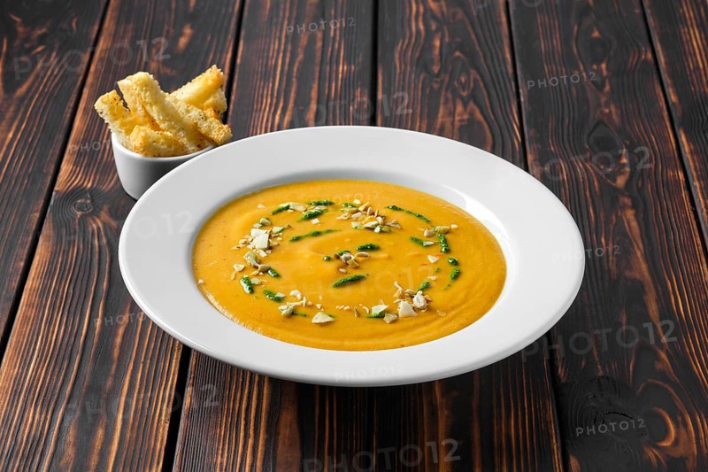 Aubergine soup puree with pumpkin seed and crouton