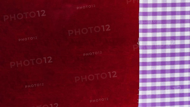Elevated view chequered pattern textile plain burgundy fabric