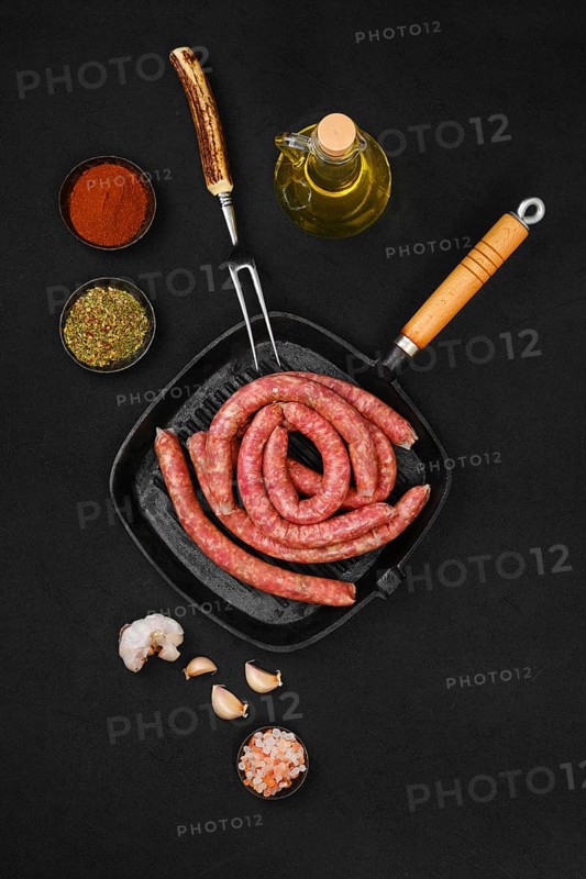 Top view of thin beef sausages on grill pan