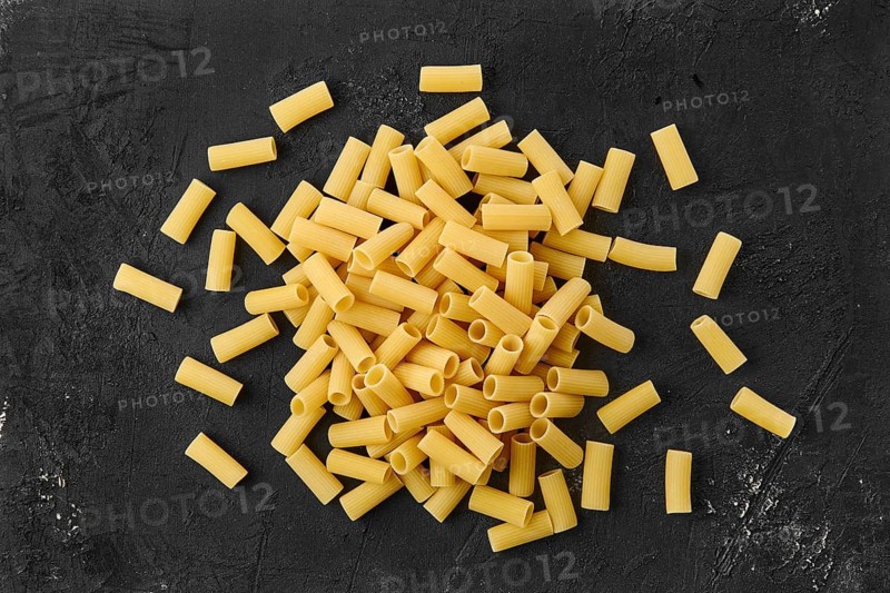 Top view of rigatoni pasta on black table