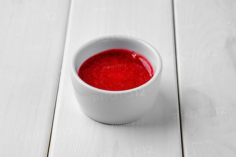 Strawberry sauce in ceramic gravy boat