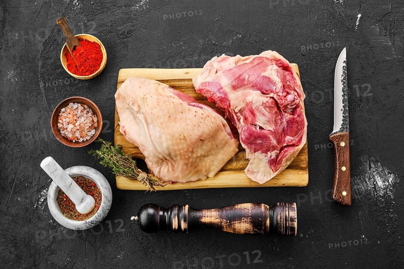 Top view of raw fresh turkey thigh with spices