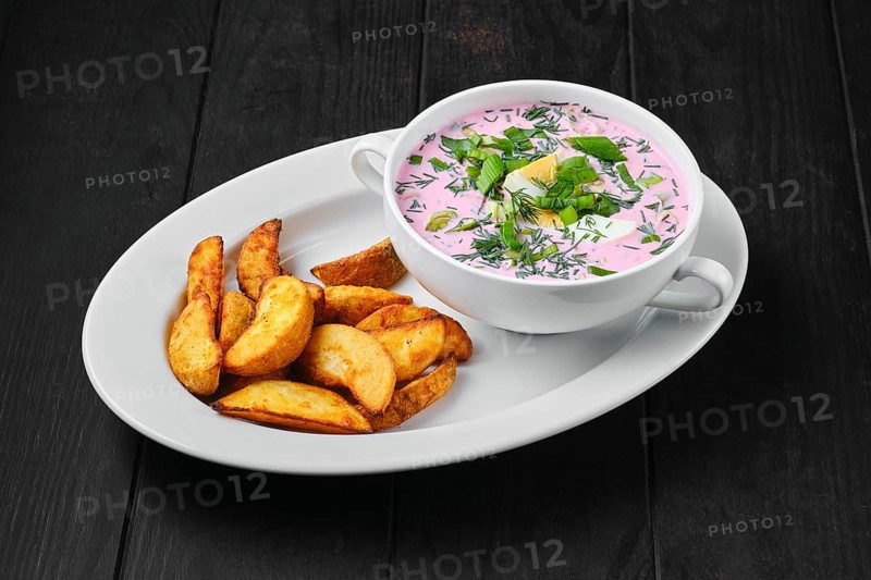 Cold beet soup with potato wedges on a plate