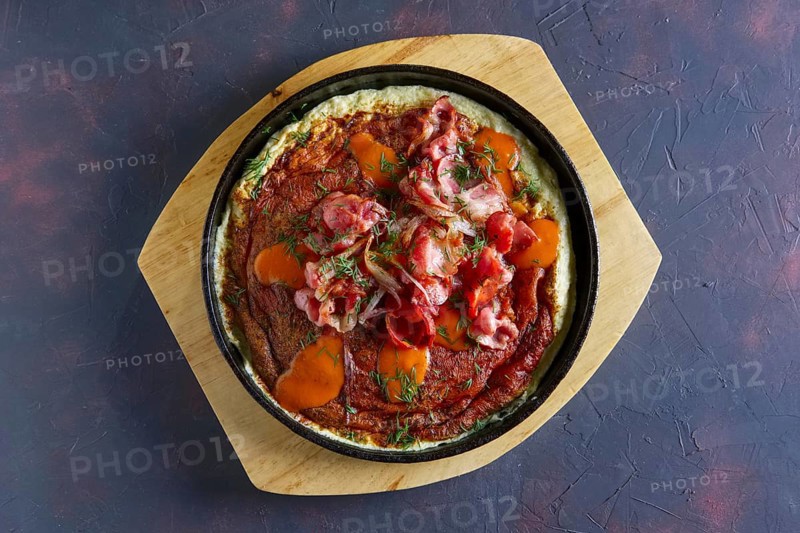 Top view of omelette with bacon. Rural breakfast