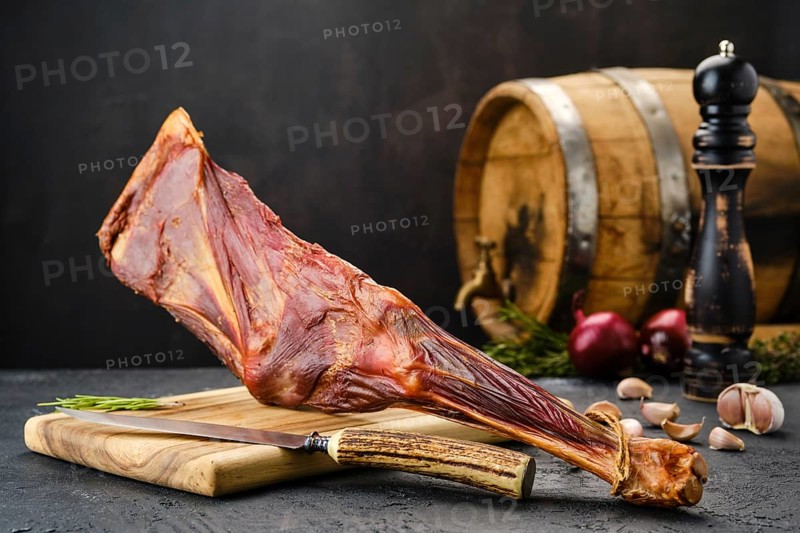 Air dried lamb meat on wooden cutting board