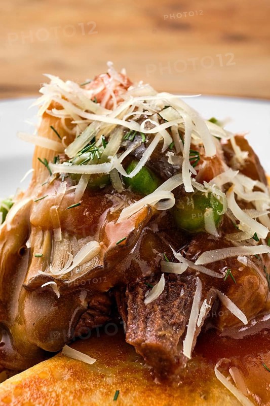 Macro photo of forest mushroom sauce on top of the food
