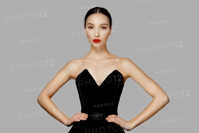 Pretty young fashion model with tan skin and red mat lips. Beauty shoot
