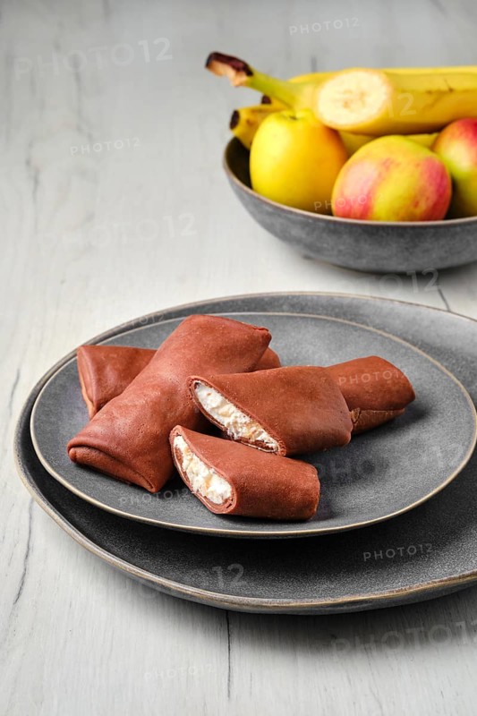 Thin chocolate pancakes stuffed with ricotta