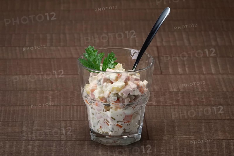 Russian traditional salad olivier with pea in glass