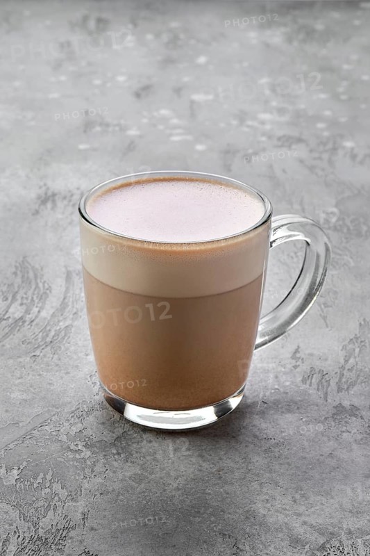 Transparent cup of cappuccino with foam