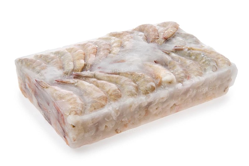 Raw tiger shrimp frozen in large ice cube isolated on white background