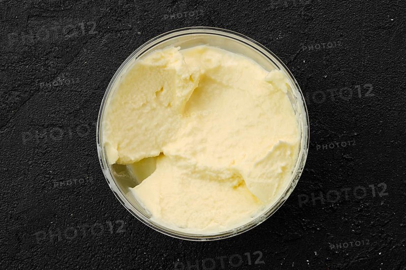 Homemade mascarpone in plastic bowl