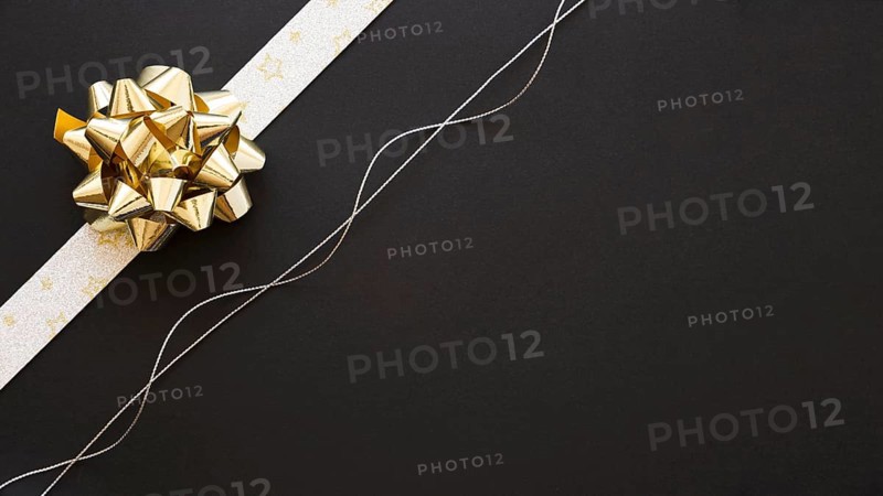 Decorative ribbon bow silver string black background