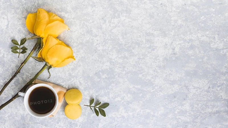 Rose flowers with macaroons coffee cup