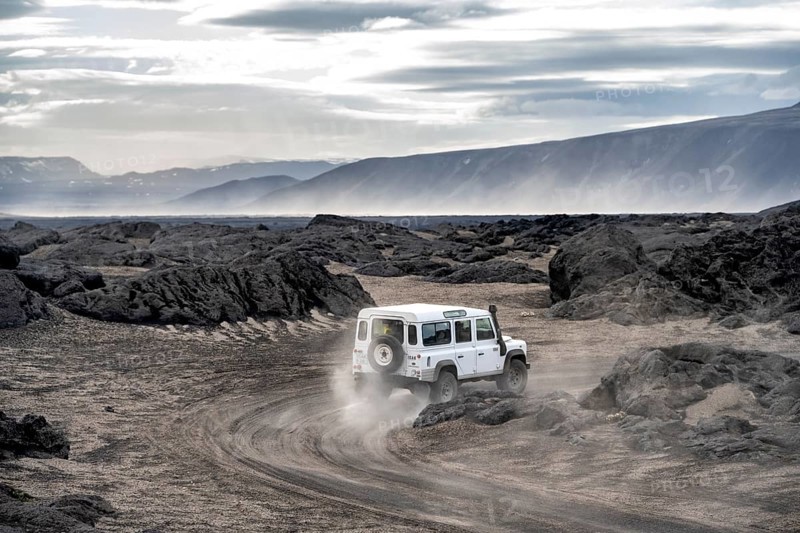White Land Rover on a dirt road