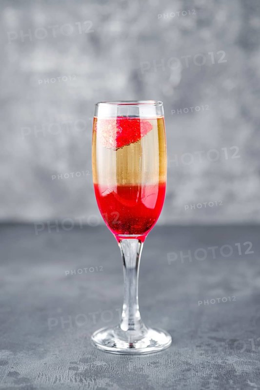 Strawberry cocktail with sparcling wine on gray shabby background