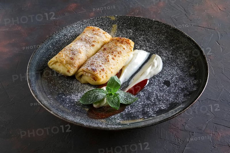 Thin pancakes with curd and sour cream