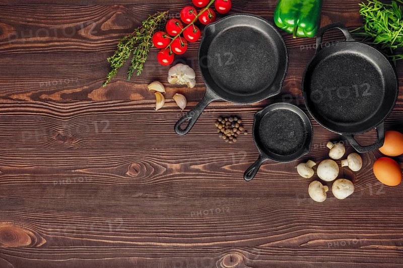 Table with cast-iron pan and spices