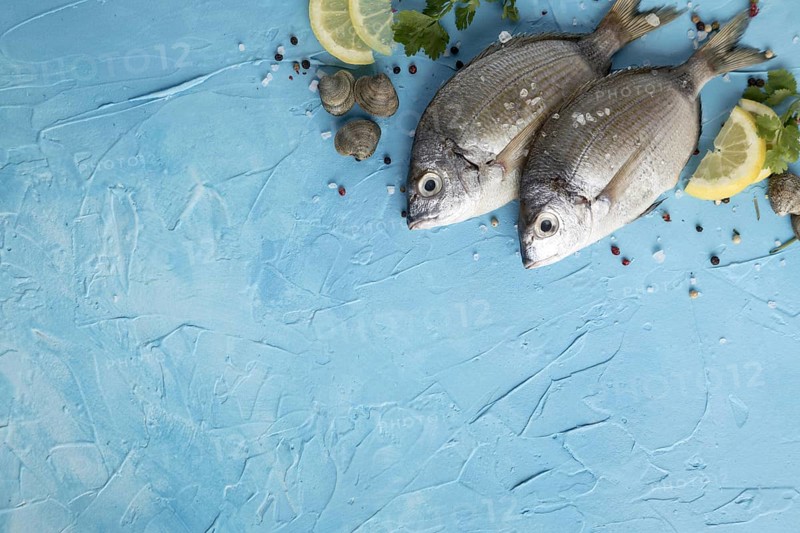 Flat lay fish with lemon copy space