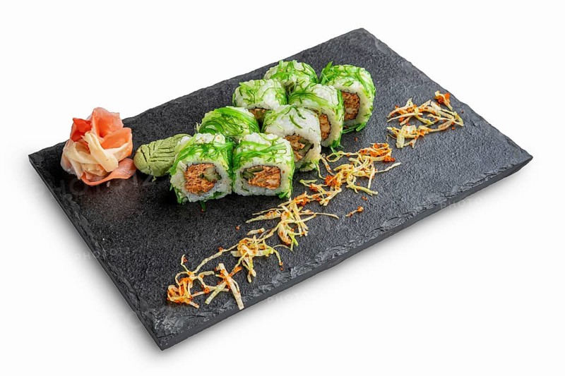 Set of rolls with wasabi and pickled ginger on stone serving board isolated on white