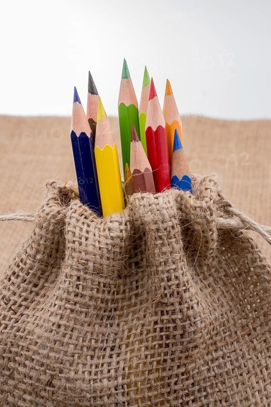 Color Pencils in a linen sack on canvas