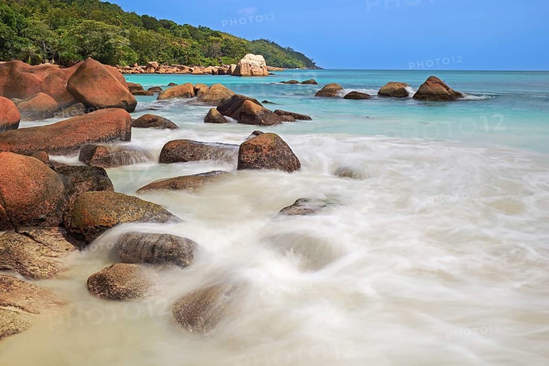 Granite rocks and beach of Anse Lazio in the evening