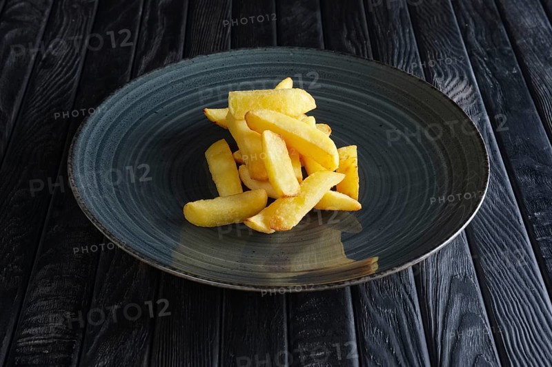 Portion of fried potato on dark wooden table
