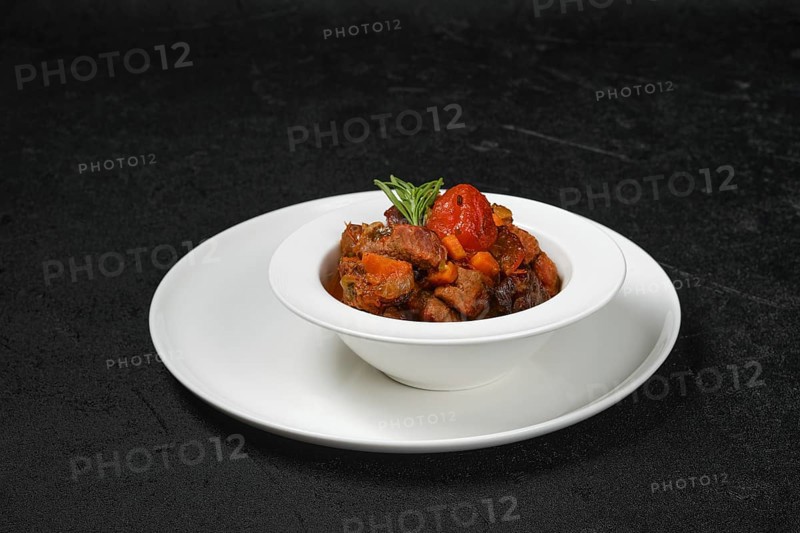 Beef stew with tomato on a plate