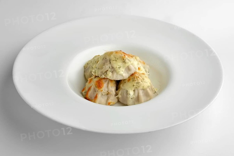 Deep plate with fried pelmeni with cheese