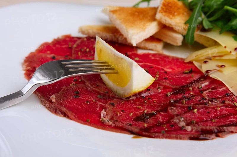 Closeup view of beef carpaccio with cheese