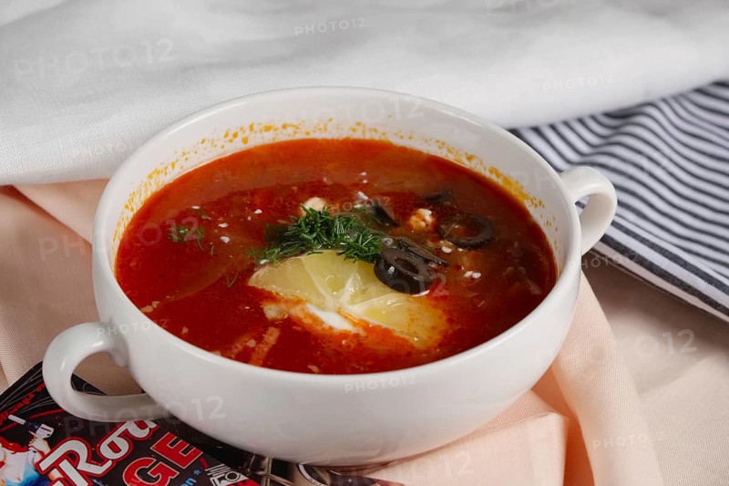 Russian traditional solyanka soup. Authentic soup saltwort in ceramic plate