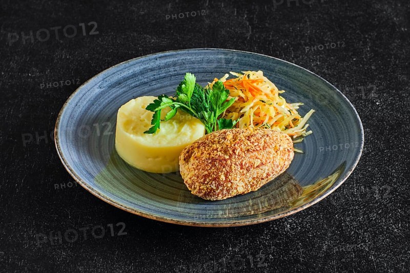 Traditional Kiev cutlet with mashed potato and pickled cabbage