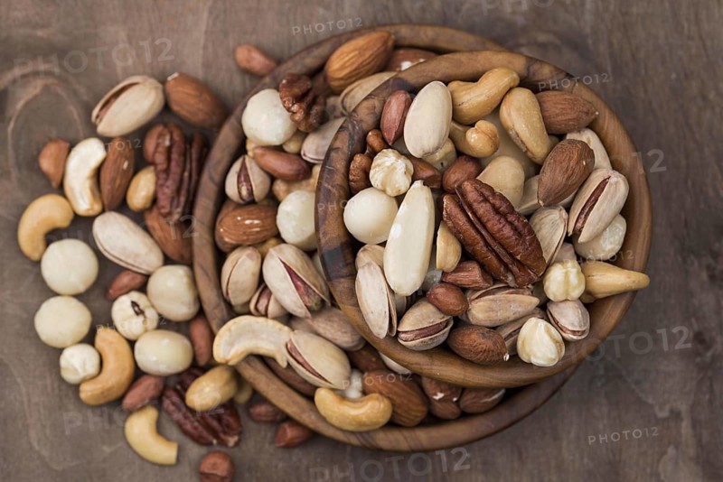 Pile bowls filled with organic nuts top view