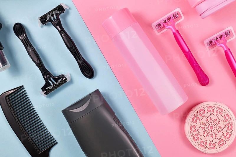 Gender tax and stereotypes concept for products marketed toward women to be more expensive than those marketed for men showing various pink and black personal care and hygiene products like shower gel