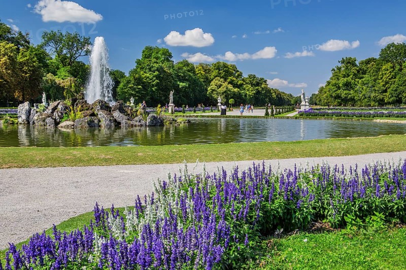 Baroque garden parterre with water fountain in the palace park of Nymphenburg Palace