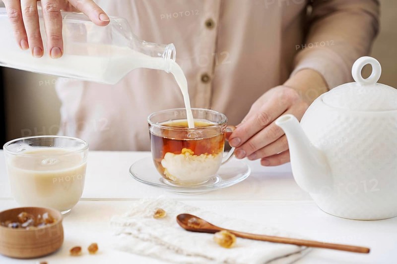 Front view person preparing milk tea