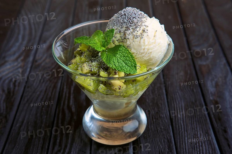A cup of apple ice cream decorated with kiwi