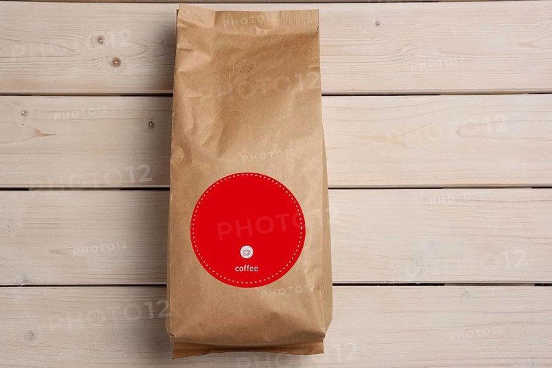 Big coffee paper pack on wooden table. Top view