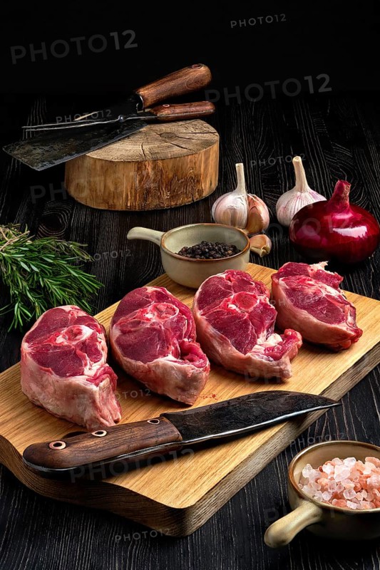 Chopped fresh lamb shank steak with spice on cutting board with spice