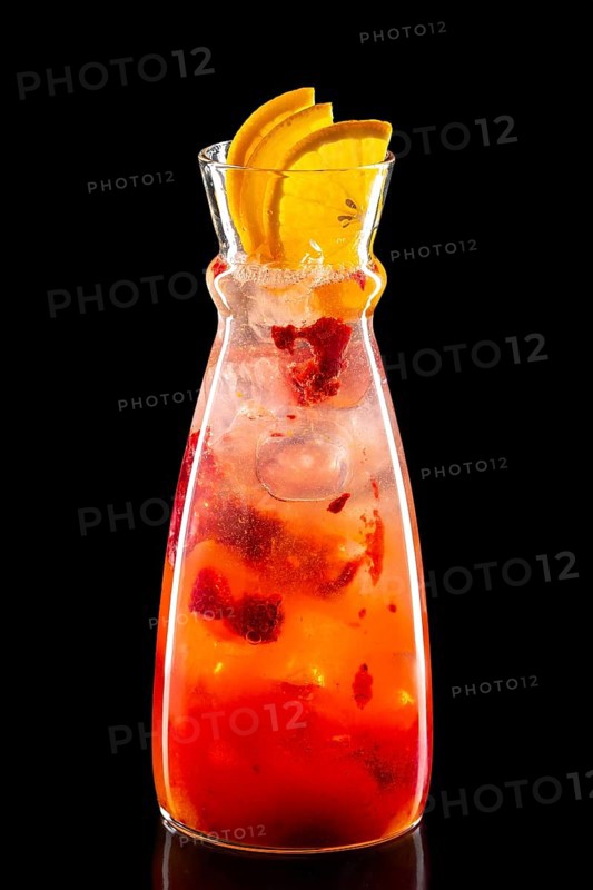 Pitcher with raspberry and orange ice lemonade isolated on black background