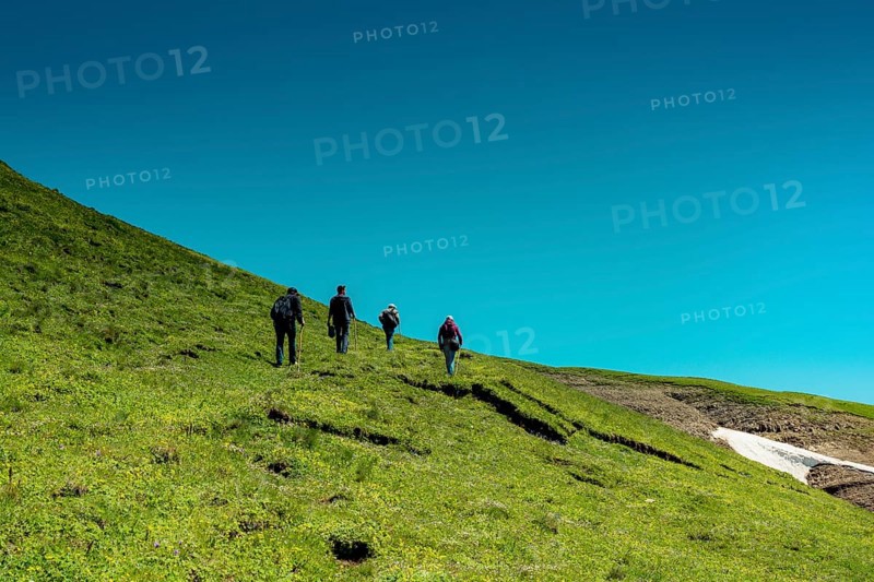 Hikers with backpacks and trekking poles walking in Turkish highland