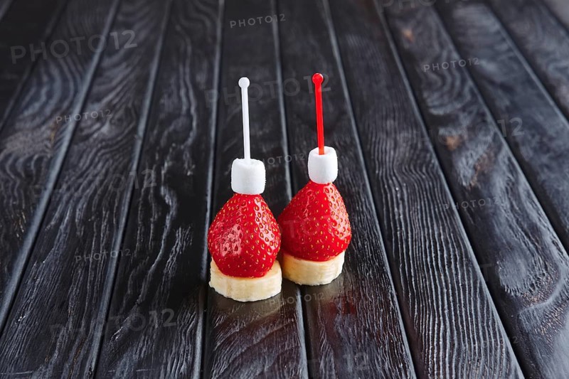 Appetizer for reception. Fresh banana with strawberry and small marshmallows on skewer