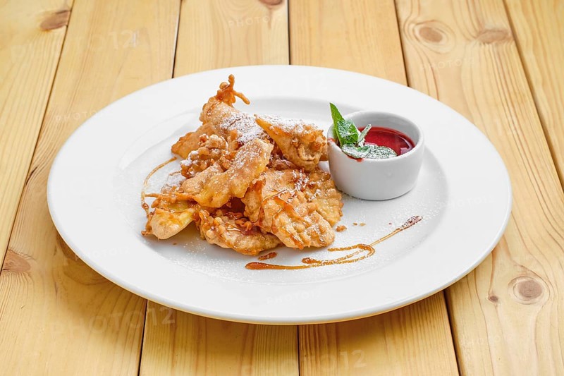 Deep fried fruits in breading served with caramel and strawberry jam