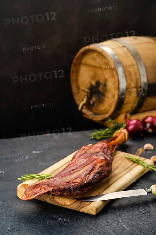 Air dried lamb meat on wooden cutting board