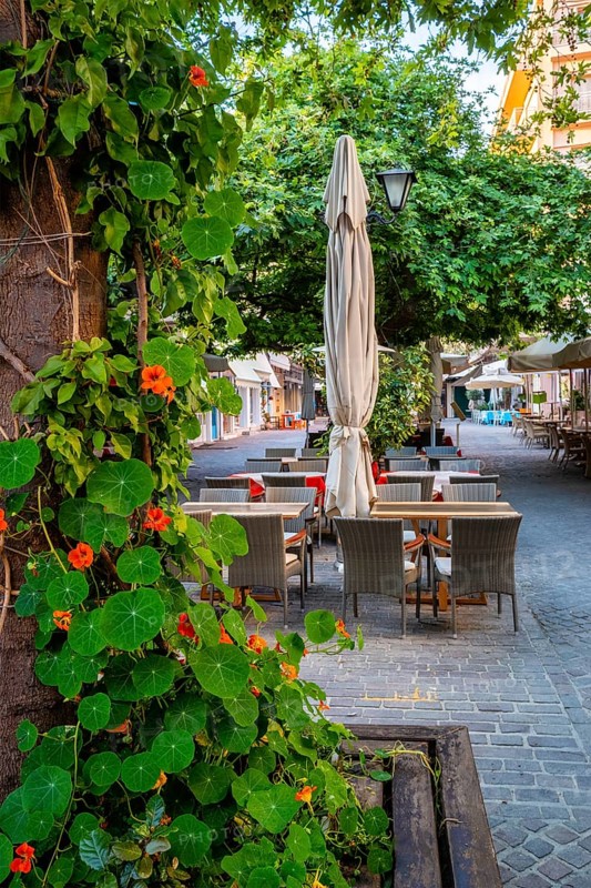 Street cafe in scenic picturesque streets of Chania venetian town with coloful old houses. Chania greek village in the morning. Chanica