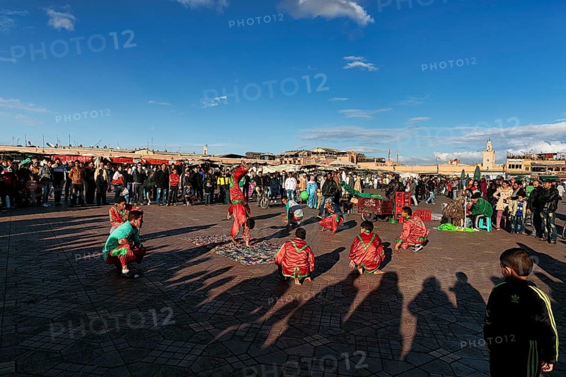 Acrobats in traditional dress in the bustling marketplace Djemaa el Fna