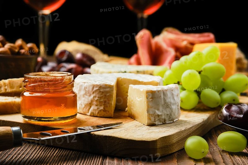 Close up view of brie cheese on plate with snack for wine