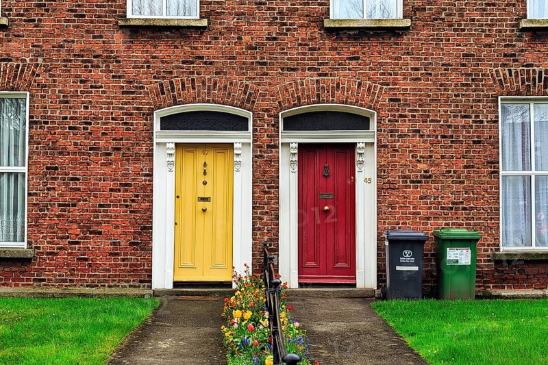 Typical terraced houses with small front garden and colourful doors
